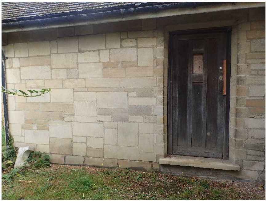 Fig. 12. Choir vestry, west wall. Ashlar of yellow-grey Weldon and light yellow Ketton. courses are commonly snecked. Door of Weldon.