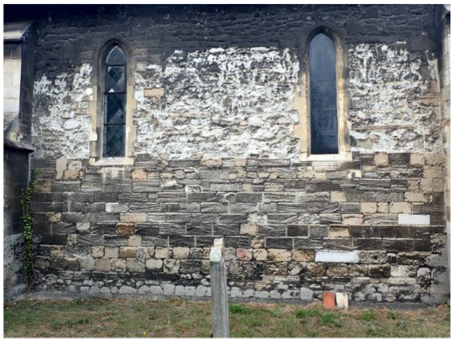 Fig. 4. Nave south wall. Clunch rubble over soot-stained, striped Ketton refacing over Barnack rubble plinth. 13th-century lancet windows entirely replaced in Ketton, possibly replacing original Clunch.